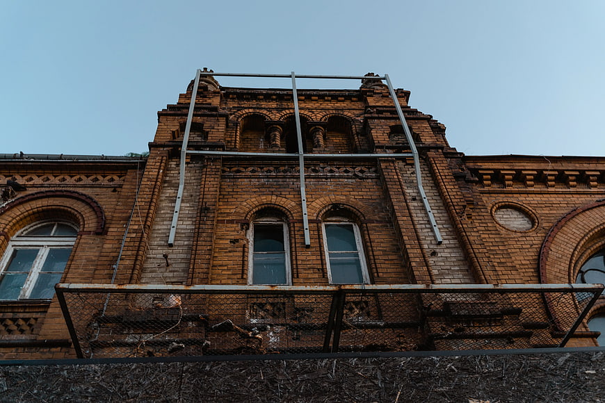Low Angle View Of Weathered Brown Brick Building Facade
