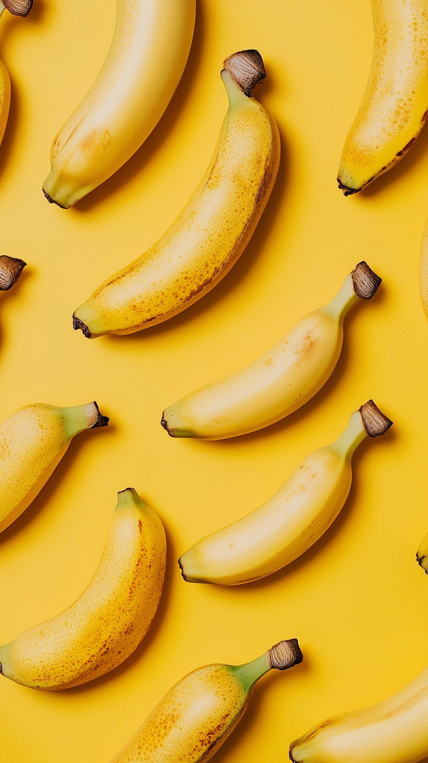 Flat Lay of Ripe Bananas on Vibrant Yellow Background
