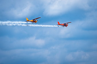 Two Aerobatic Planes Flying in Formation with Smoke Trails