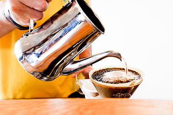 Barista Pouring Hot Water into Coffee Dripper