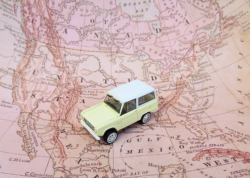 Vintage toy car on old map of North America