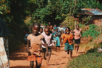 Happy African children running on a dirt road