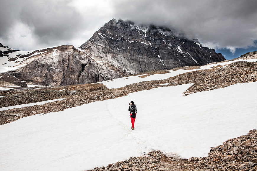 Lone Hiker Walking on Snowy Mountain Path