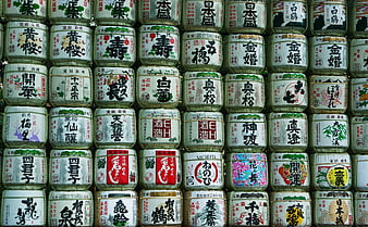 Traditional Japanese sake barrels with calligraphy labels