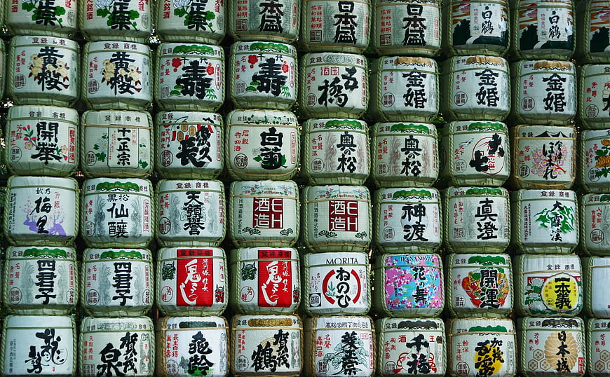 Traditional Japanese sake barrels with calligraphy labels