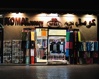 Komal Fashion Shop Front at Night with Fabric Displays