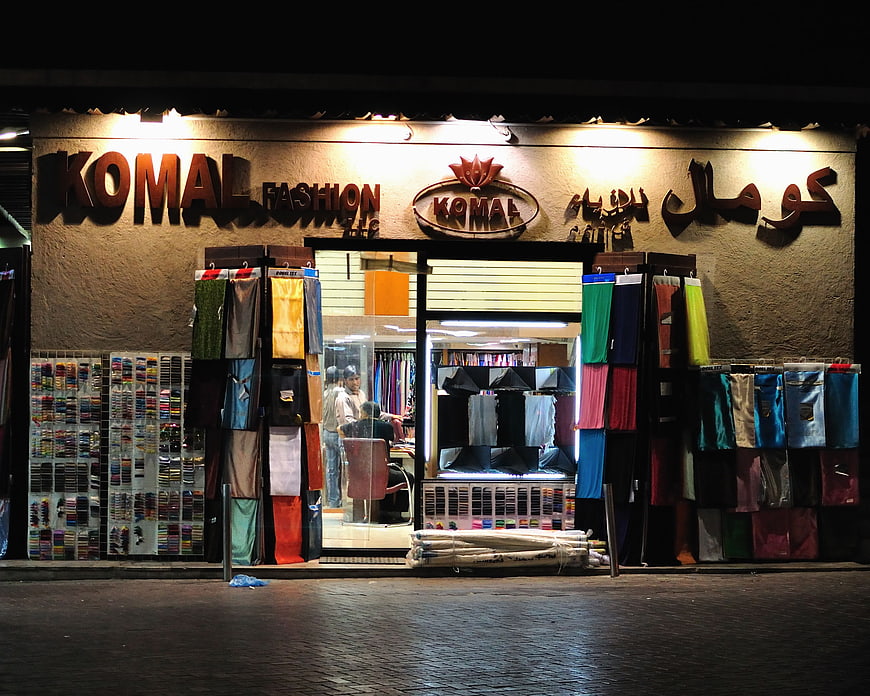 Komal Fashion Shop Front at Night with Fabric Displays