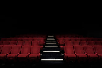 Dark Empty Cinema Auditorium with Red Seats