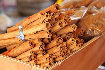 Close-up of cinnamon sticks in a wooden box at a market