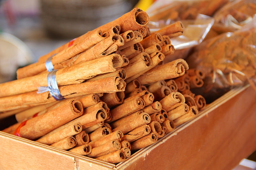 Close-up of cinnamon sticks in a wooden box at a market