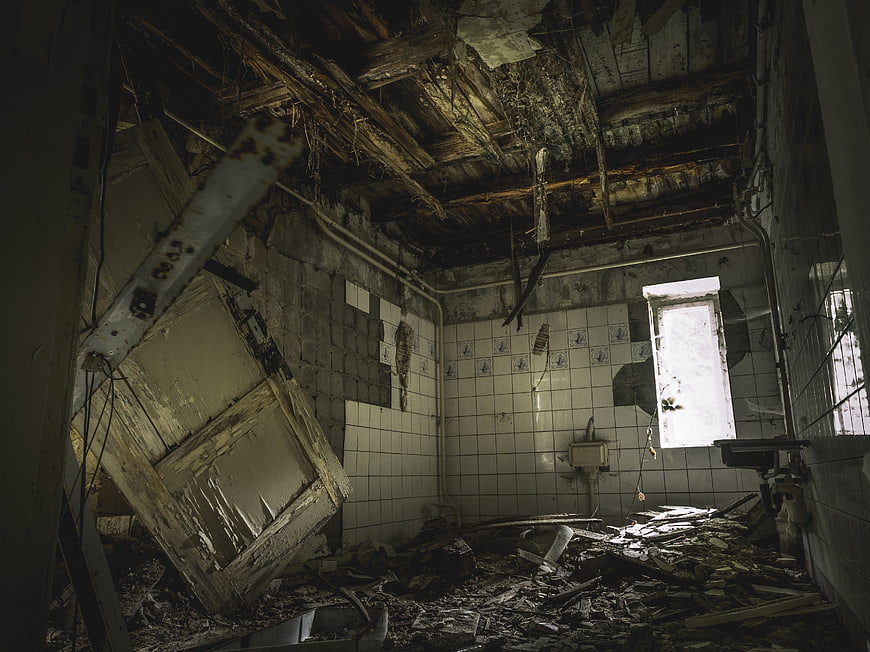 Abandoned Dilapidated Bathroom Interior with Debris