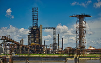 Rusty Industrial Steel Structures And Factory Complex Under Blue Sky