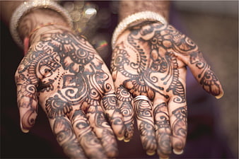 Close-up of hands with intricate henna mehndi designs