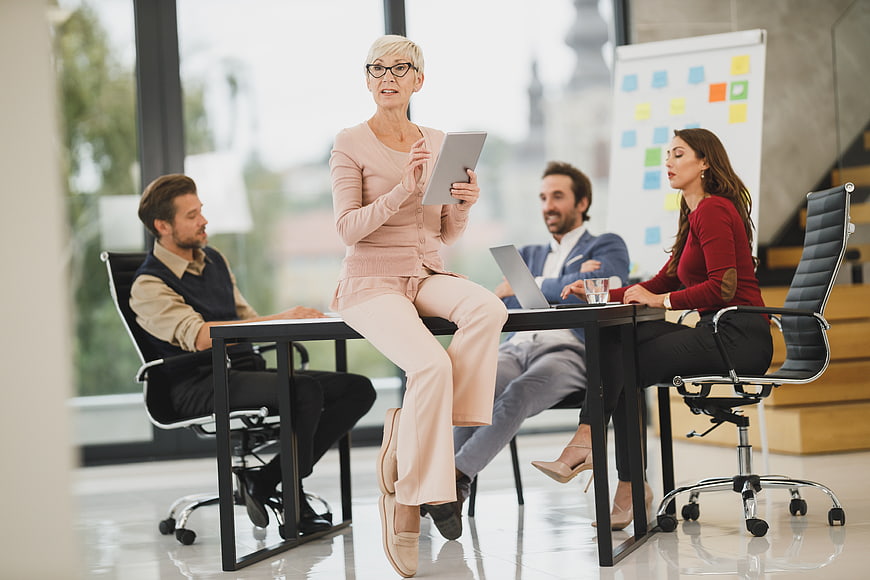 Senior female manager leading business meeting with team