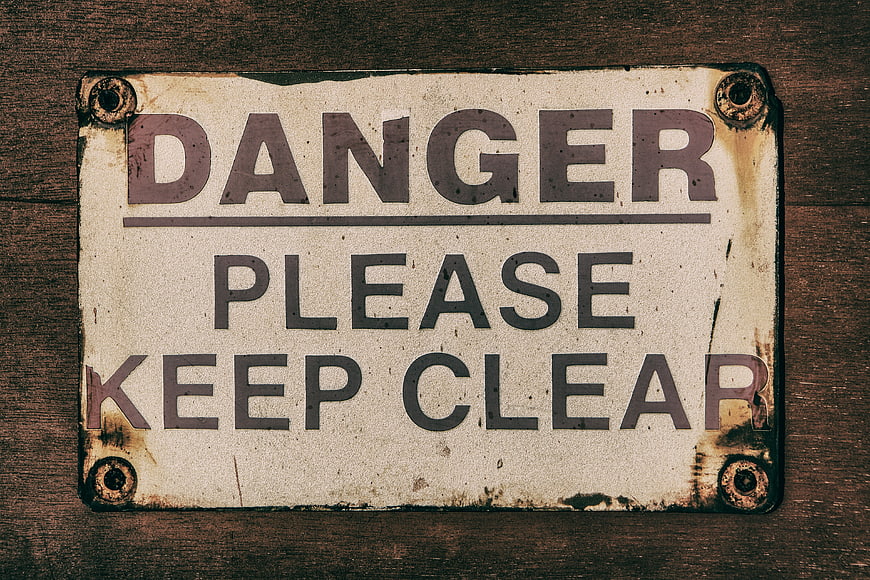 Vintage Danger Please Keep Clear Metal Sign on Wood