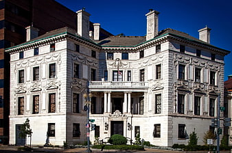 Grand White Neoclassical Mansion Under Blue Sky