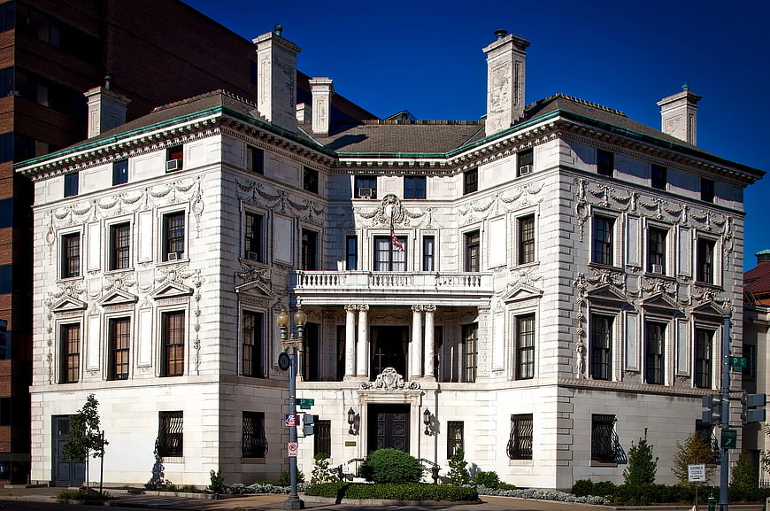 Grand White Neoclassical Mansion Under Blue Sky
