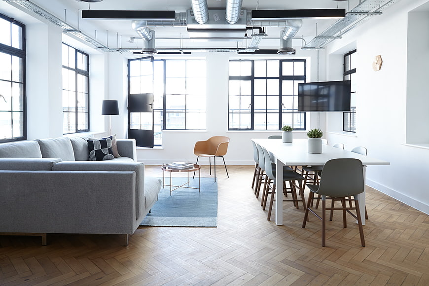 Modern industrial loft office with herringbone floors and exposed ducts