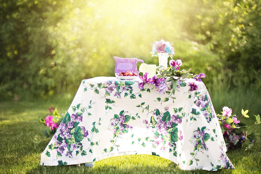 Summer Garden Tea Party Setup with Floral Tablecloth