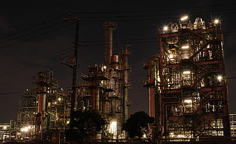 Illuminated Oil Refinery Complex At Night With Industrial Structures