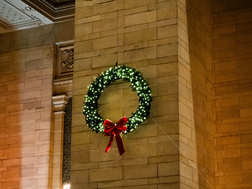 Christmas Wreath with Red Bow on Stone Wall