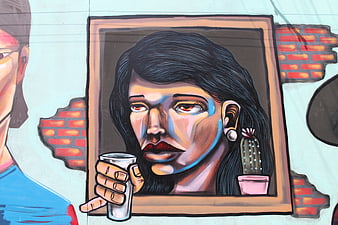 Street art mural of a woman holding a glass in a window frame