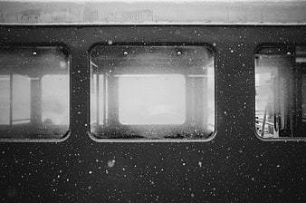 Black and white photo of subway windows in snow