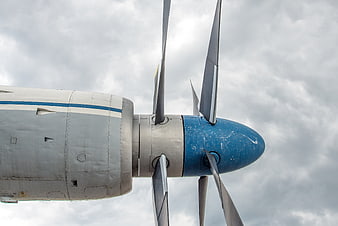Close-up of vintage propeller airplane engine against cloudy sky