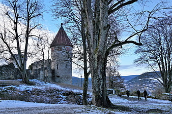 Historic Castle Ruins and Tower in Snowy Winter Landscape