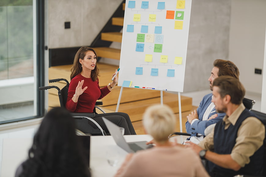 Woman in Wheelchair Leading Business Strategy Meeting