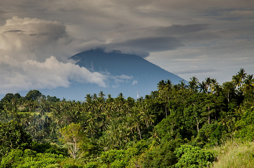 Tropical Volcano Landscape with Palm Trees and Clouds