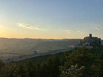 Spis Castle Ruins at Sunrise Over Rolling Hills