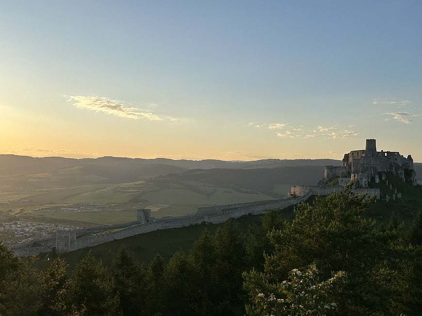 Spis Castle Ruins at Sunrise Over Rolling Hills