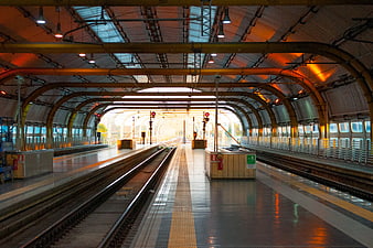 Empty Train Station Platform with Arched Ceiling and Tracks