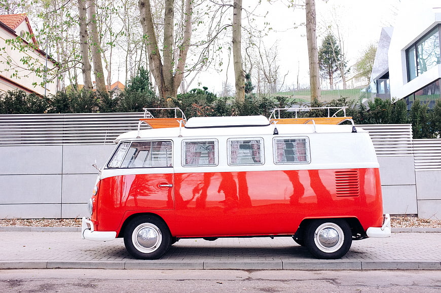 Vintage Red and White Volkswagen Bus Parked on Street