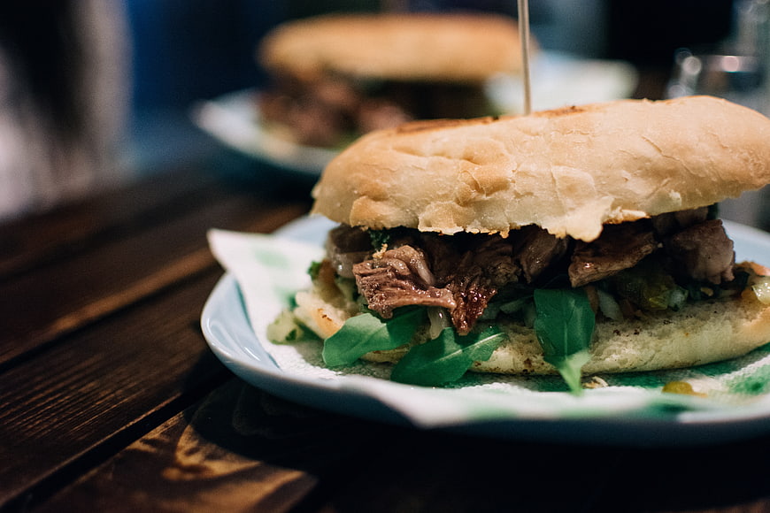 Close-up of Argentinian beef steak sandwich on wooden table
