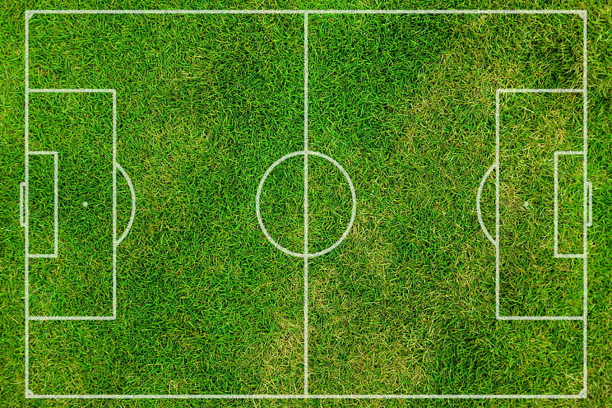 Aerial view of a green soccer field with white lines