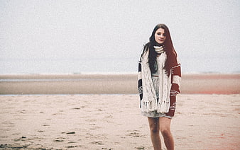 Woman in Knitwear Standing on Sandy Beach