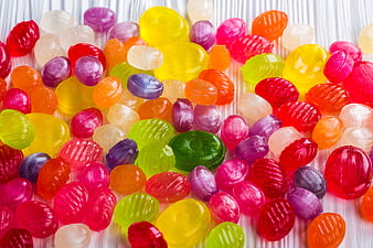 Colorful Jelly Beans Scattered on White Wooden Background