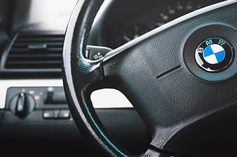 Close-up of BMW steering wheel and car interior dashboard