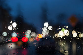 Raindrops on Car Windshield with City Bokeh Lights