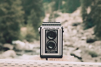 Vintage Spartus Full-Vue Camera on Wooden Post Outdoors