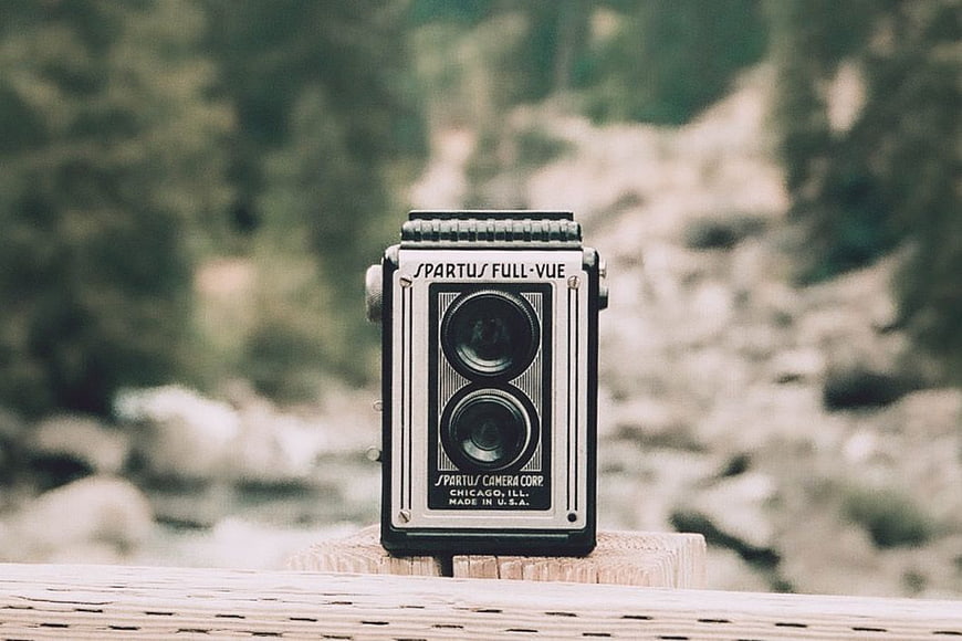 Vintage Spartus Full-Vue Camera on Wooden Post Outdoors