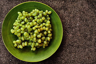 Green Grapes In Green Bowl On Dark Textured Surface