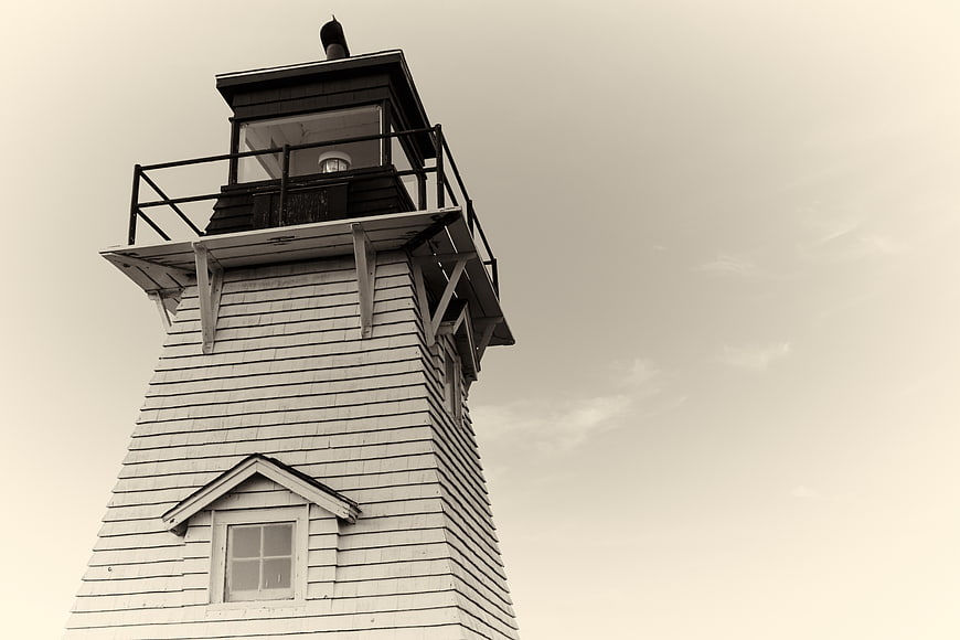 Low angle view of vintage lighthouse tower against sky