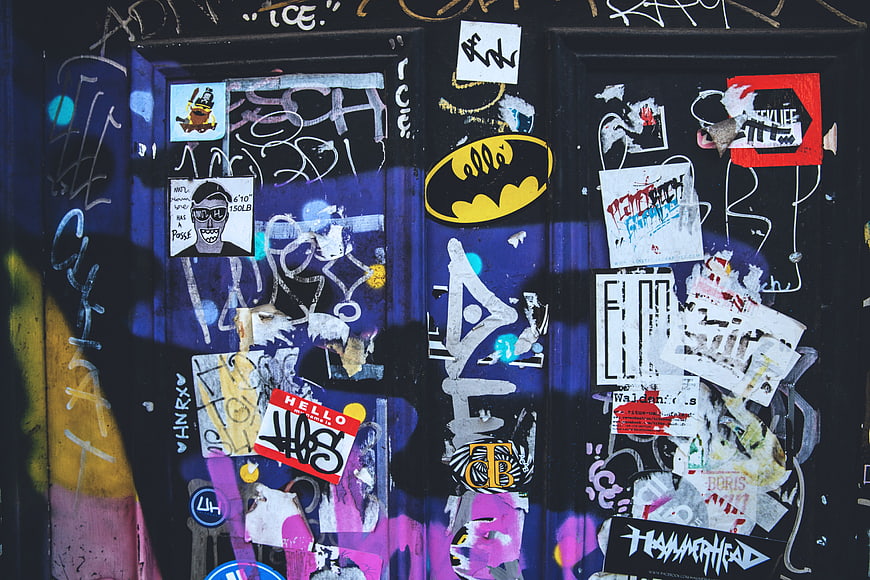 Urban Street Art Wall with Batman Sticker and Graffiti