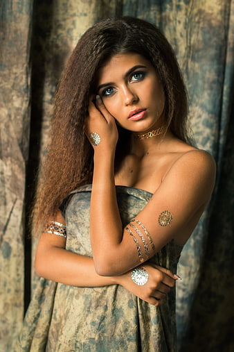Portrait of Woman with Gold Body Jewelry and Blue Eyes