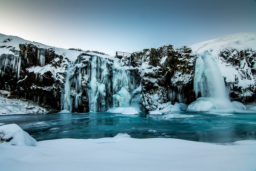 Frozen Waterfall in Snowy Winter Landscape