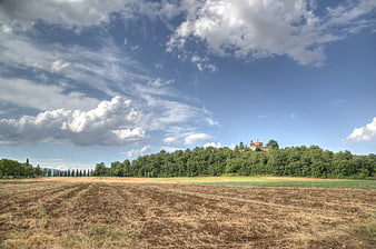 Tuscan landscape with plowed field and villa