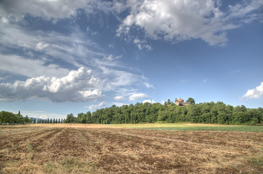 Tuscan landscape with plowed field and villa